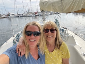 Learn to Sail - Female friends on a sailboat - taking sailing course